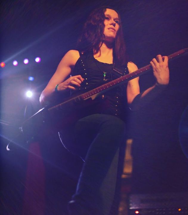 Jess on stage playing guitar